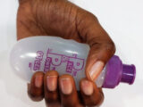 Female hand with pocket bottle